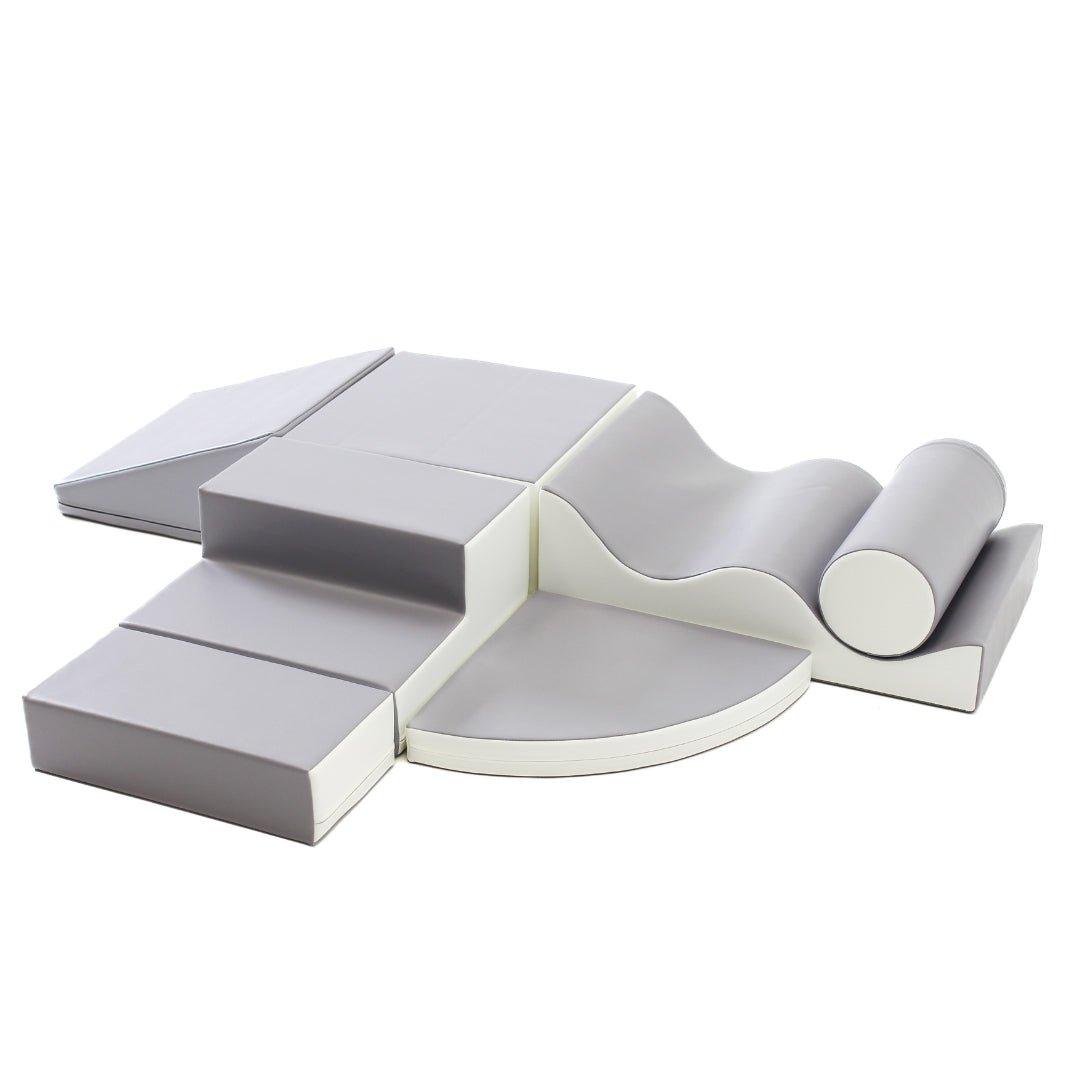 Grey and white soft play set arranged by various shapes, including wedges, steps, squares, and more