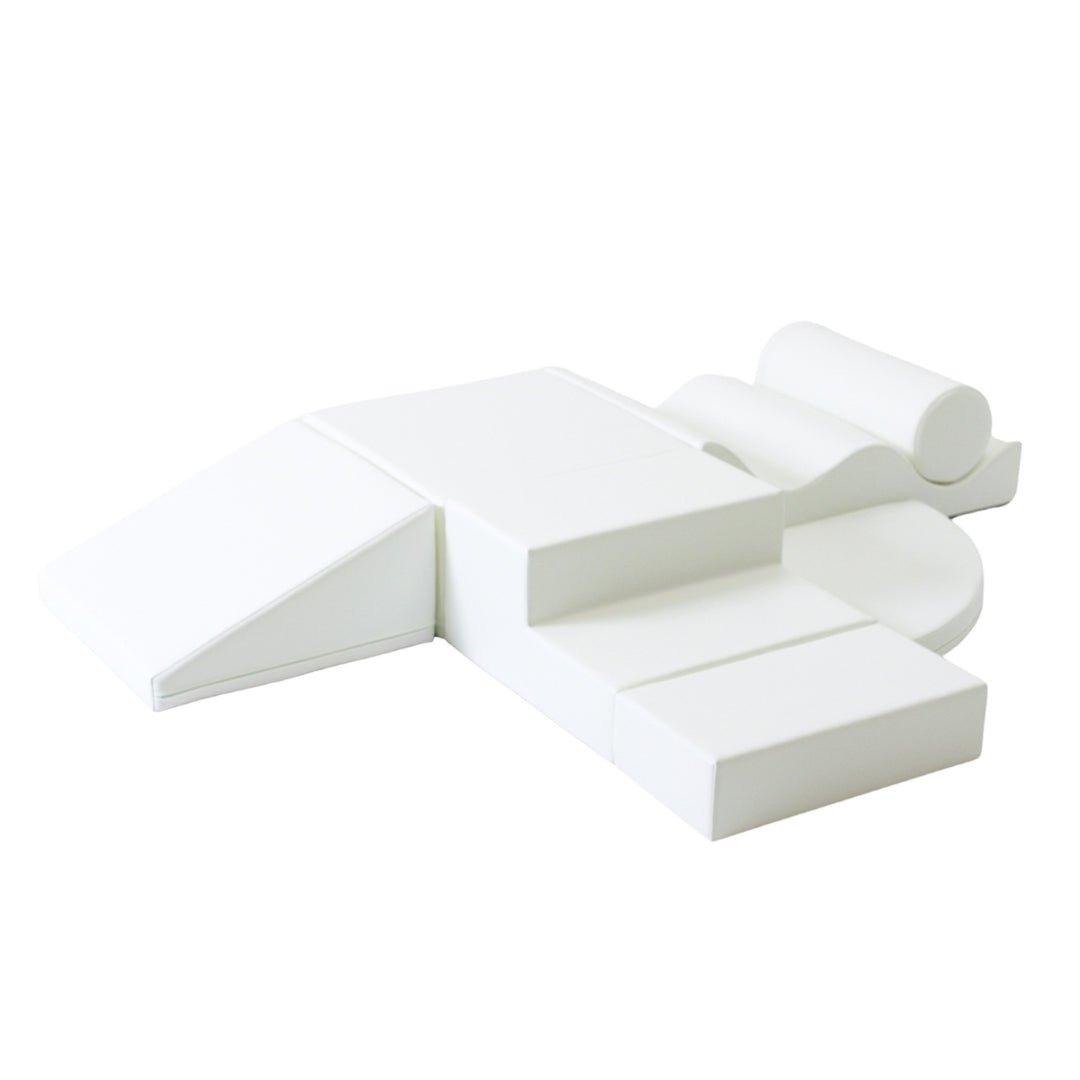 White soft play set arranged by various shapes, including wedges, steps, squares, and more