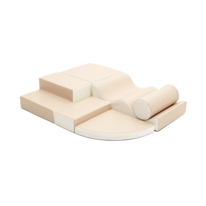 Beige soft play set made from various shapes like a square, cylinder, a wedge, and steps
