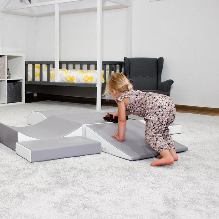 A little girl engaging in interactive play on an IGLU Soft Play - Little Crawler XL, stimulating imagination and supporting physical development.