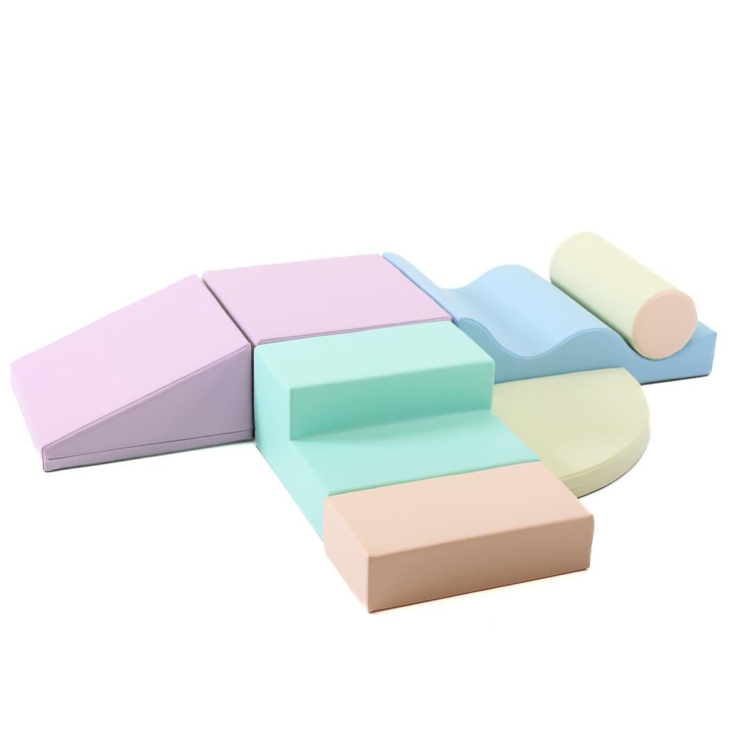 Light pastel multicolored soft play set arranged by various shapes, including wedges, steps, squares, and more