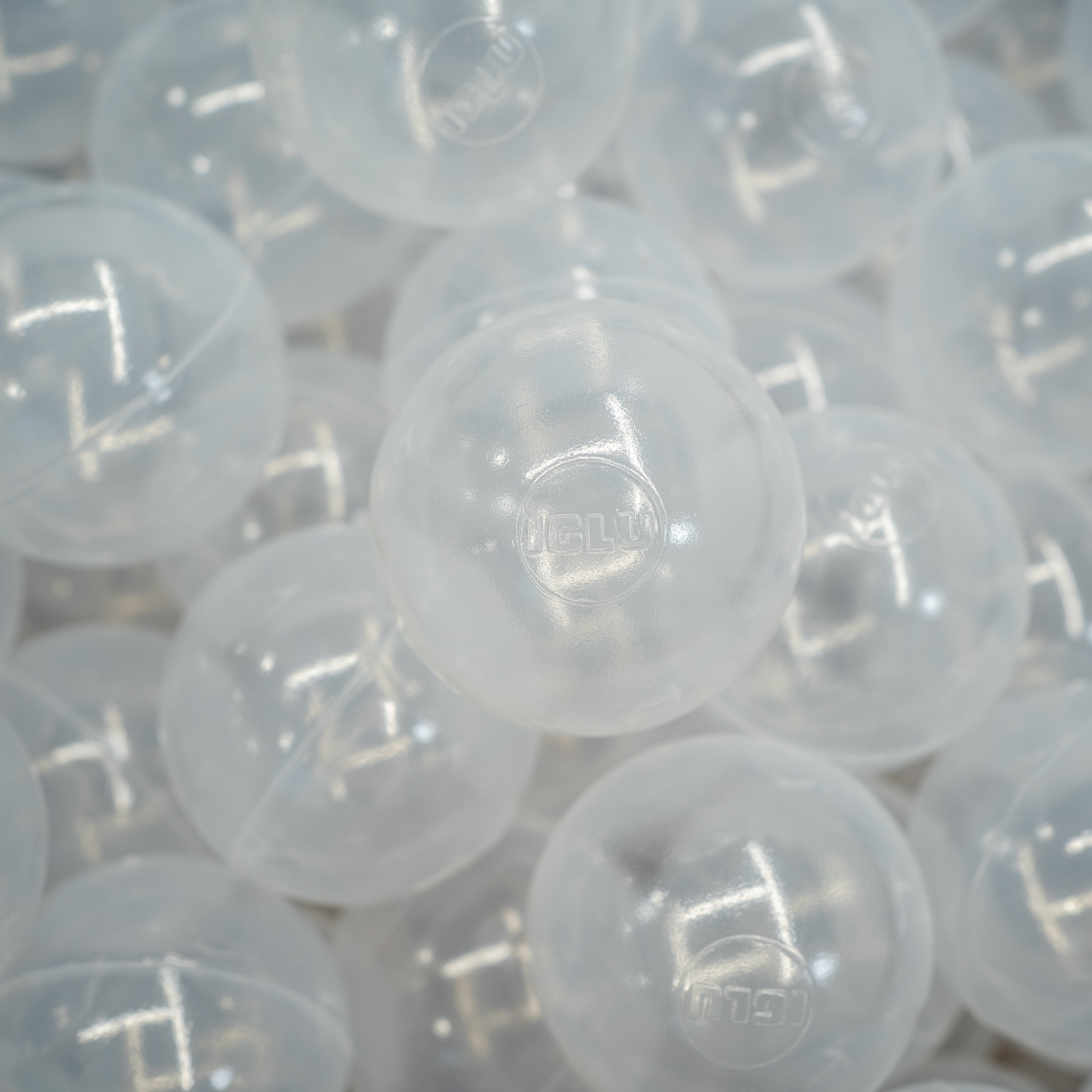 Lots of transparent large plastic ball pit balls.