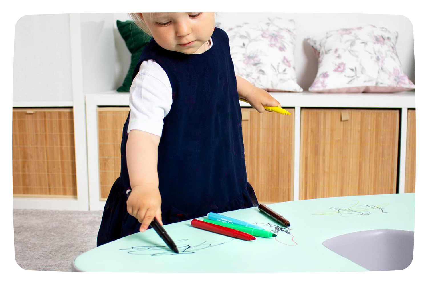 A girl drawing with markers on her IGLU set