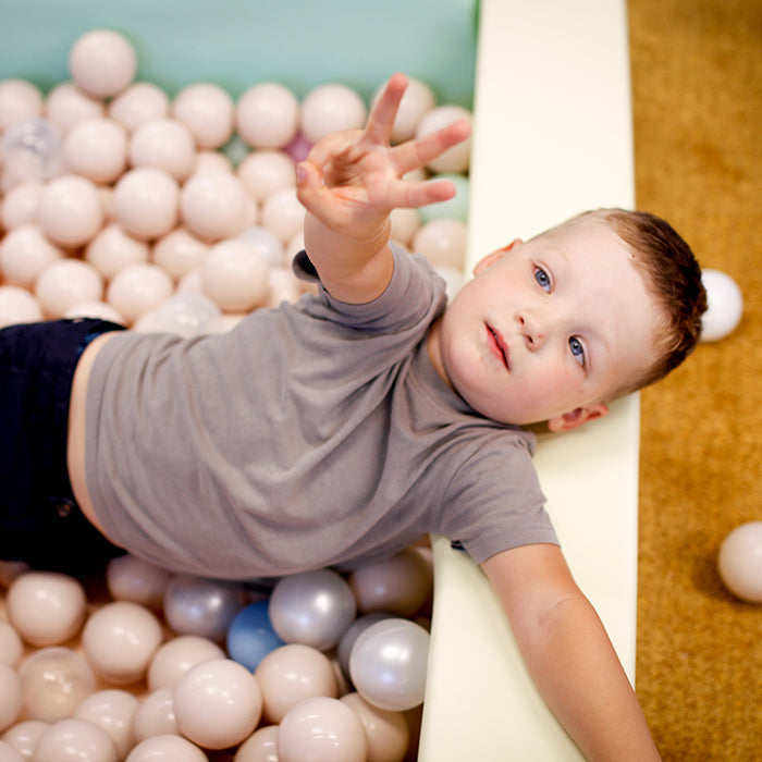 A boy playing in an IGLU pall pit