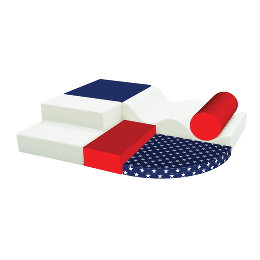 Soft play equipment in American flag colors arranged from shapes like steps, squares, a cylinder, and star-patterned semicircle