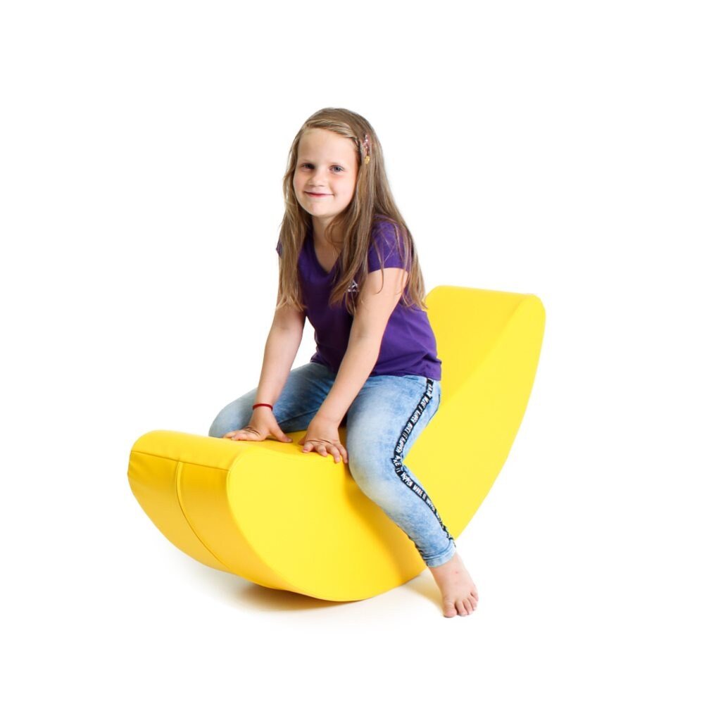 Smiling girl sitting on a yellow soft play rocker shaped like a banana 