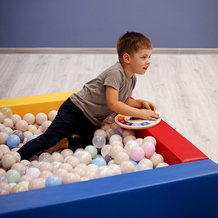A boy playing in an IGLU ball pit