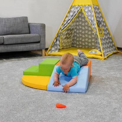 An IGLU Soft Play Corner Crawler is laying on a teepee in a living room.