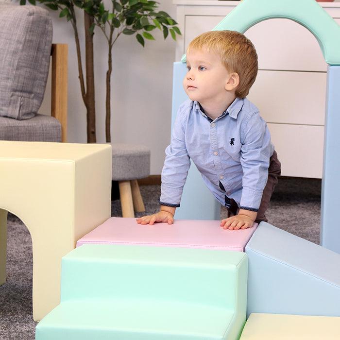 A young boy is exploring an IGLU Soft Play Multifunctional Foam Play Set - Creativity.
