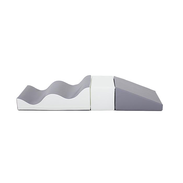 A grey and white box with a wavy shape promoting creativity and coordination, the Soft Play Set - Wave Walk by IGLU Soft Play.