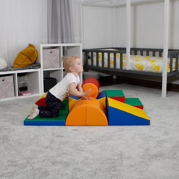A child is engaged in physical activity with the Soft Play Activity Set - Adventurer by IGLU Soft Play in a room.