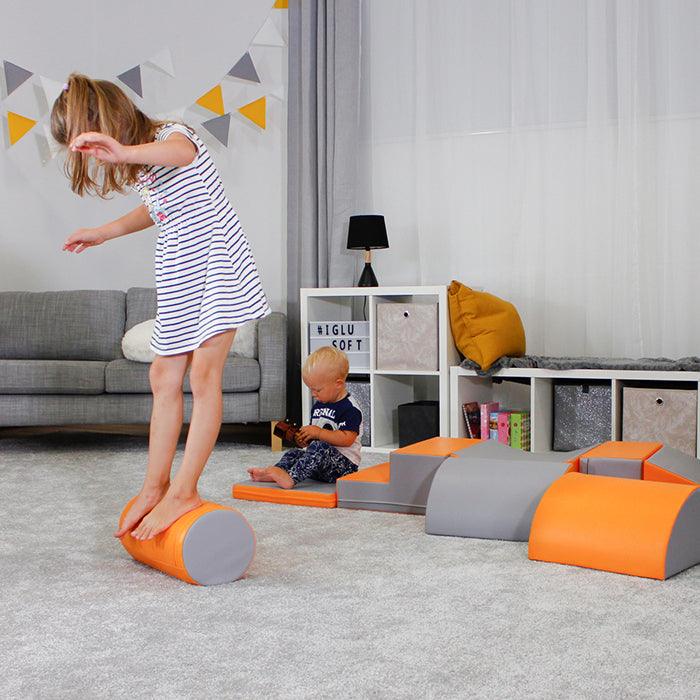 A child is engaging in imaginative play with the Soft Play Activity Set - Adventurer by IGLU Soft Play in a living room.