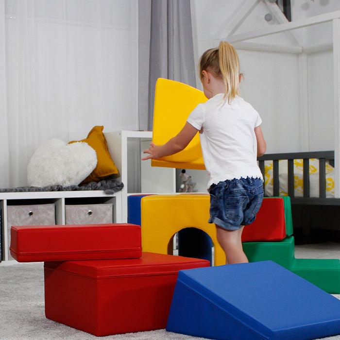 A little girl playing with an IGLU Soft Play - Castle in a room.