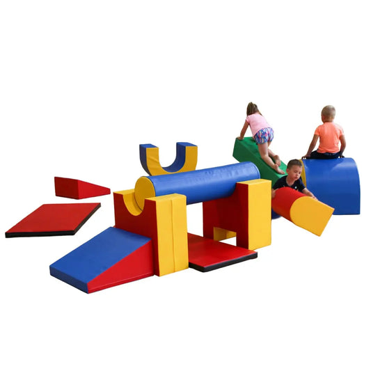 Children climbing on colorful soft play shapes arranged as an obstacle course. Includes cylinders, rectangles, and wedges