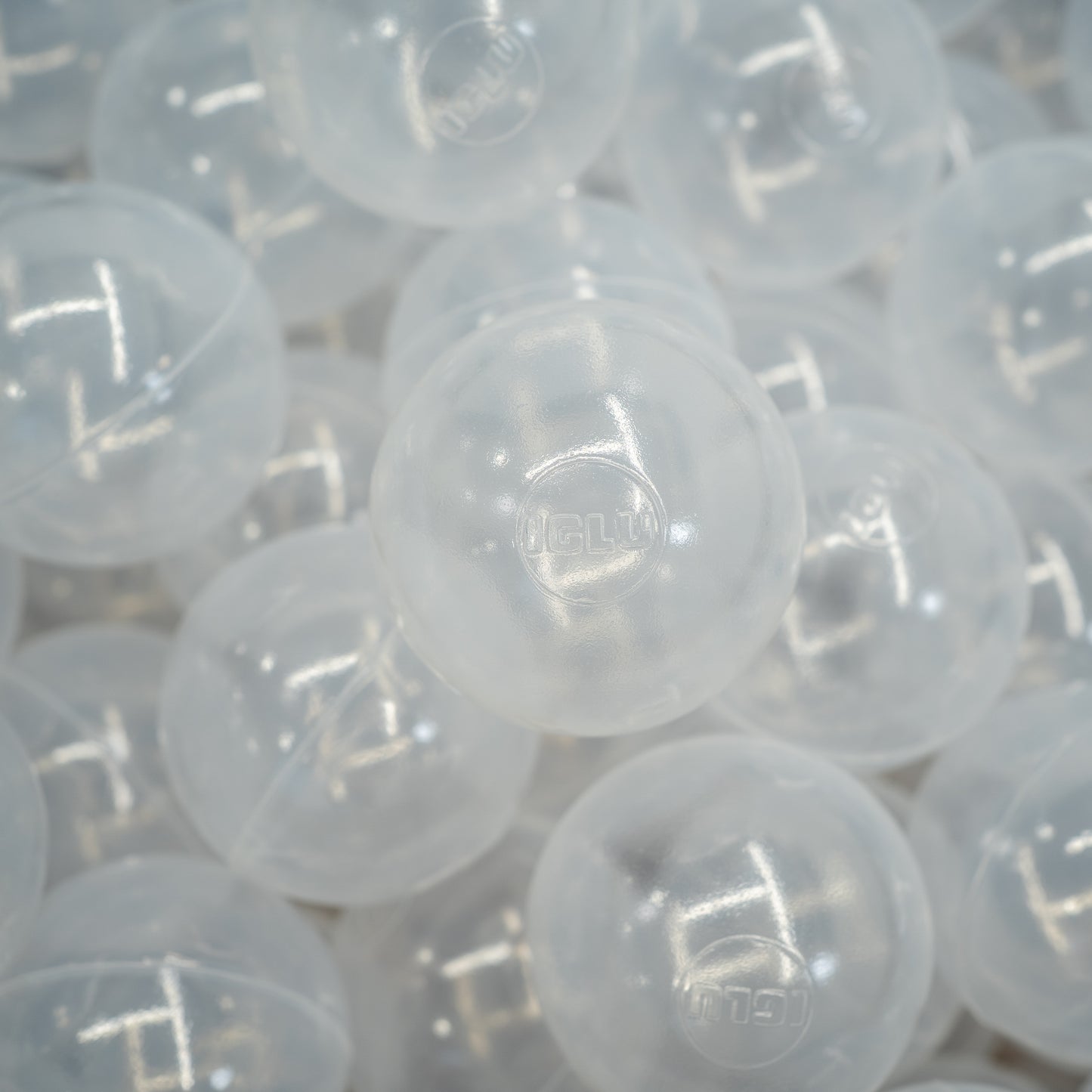 Lots of transparent large plastic ball pit balls.