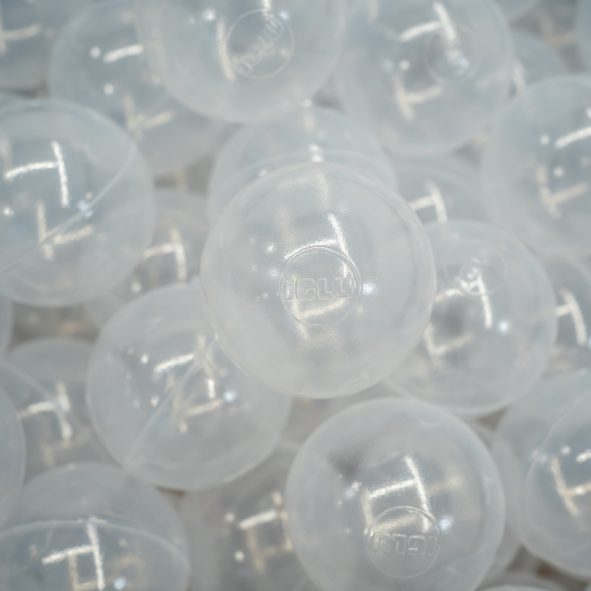 Lots of transparent large plastic ball pit balls.