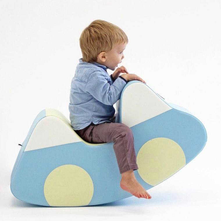 A boy rocking on an IGLU rocking toy
