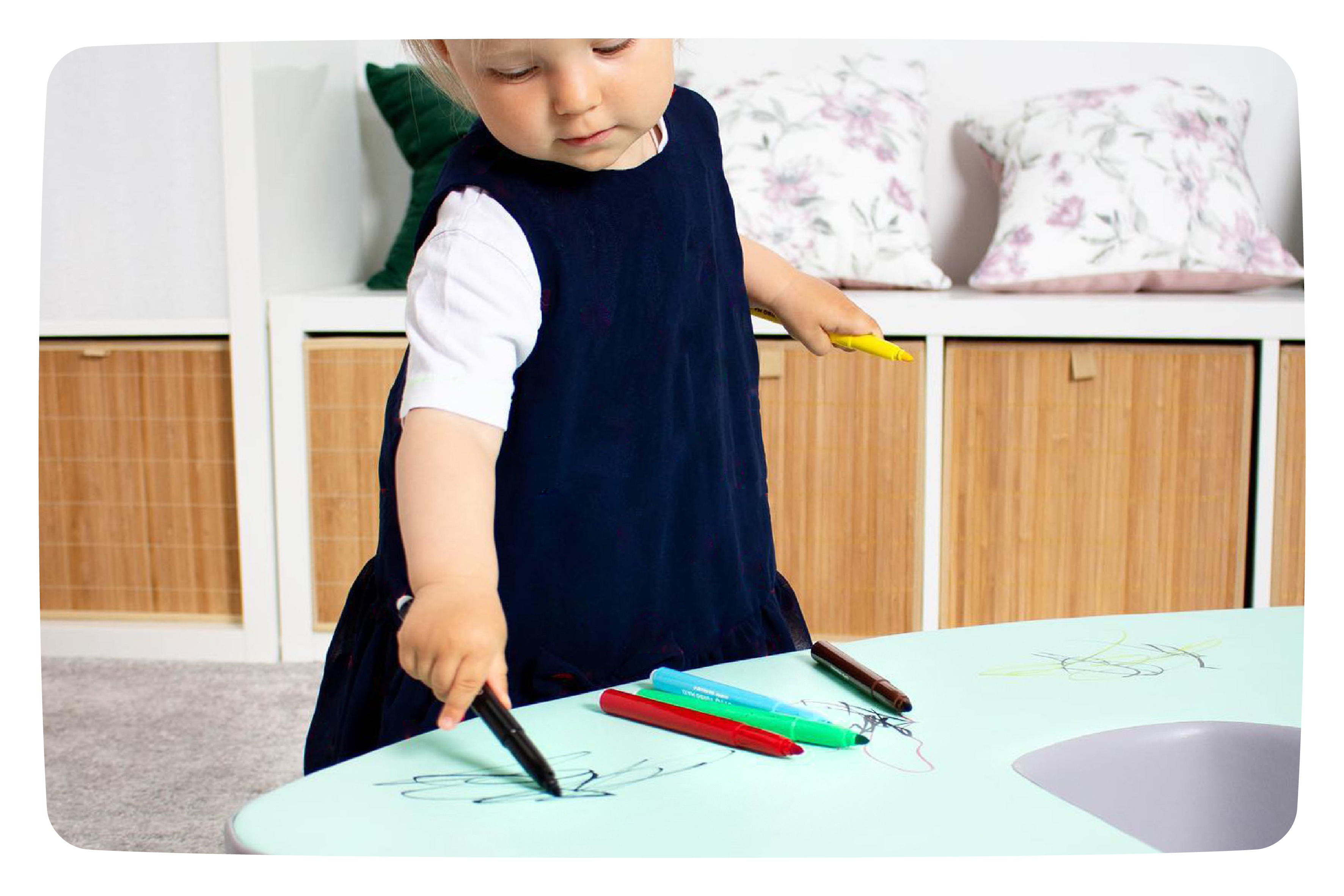 A girl drawing with markers on her IGLU set