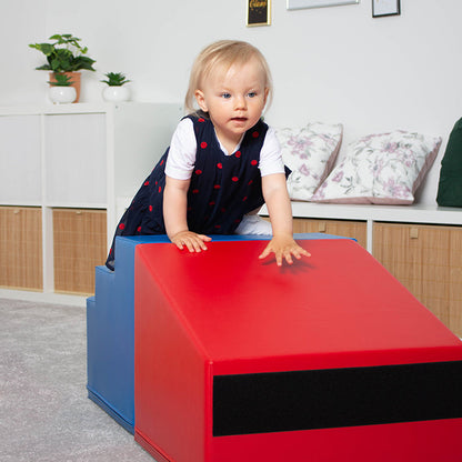 A girl climbing on a red and blue IGLU set